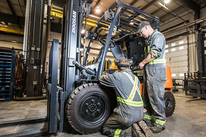 Technicians working on forklift
