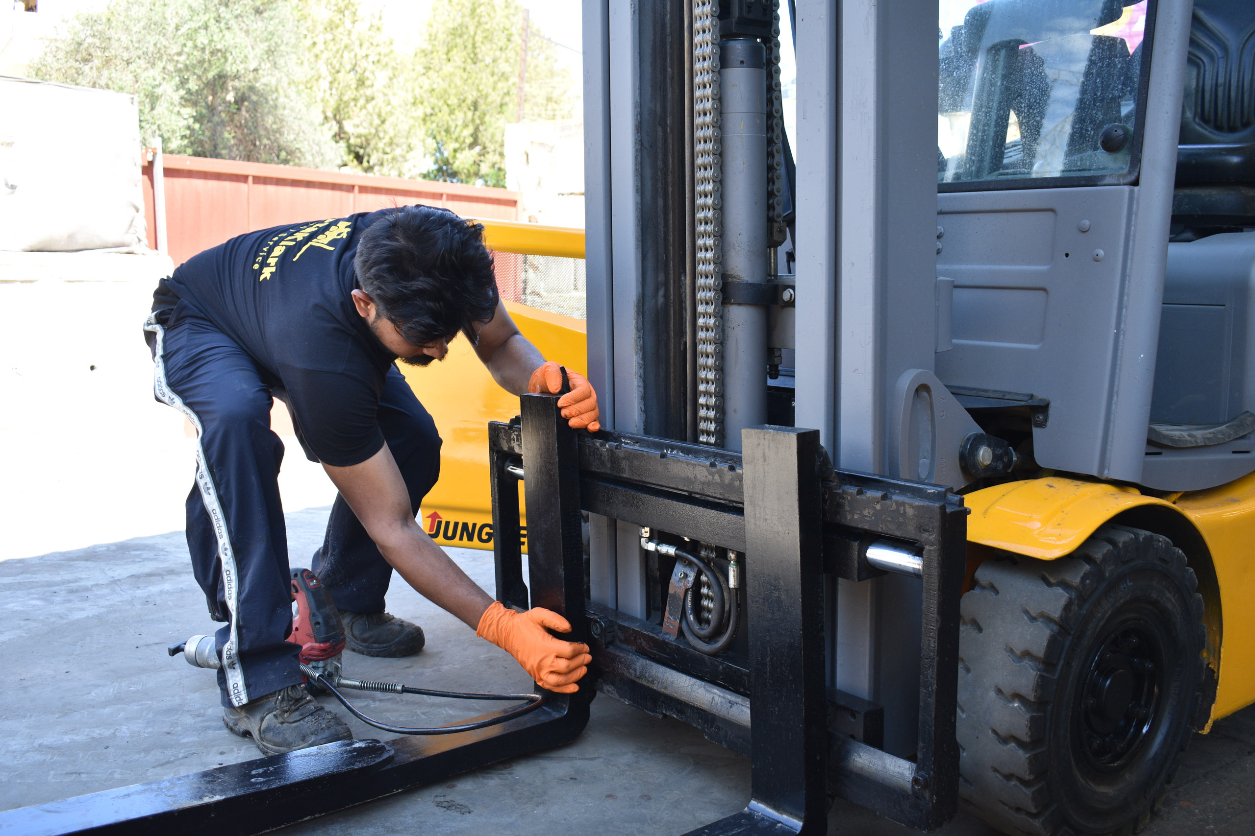 Technicians working on forklift